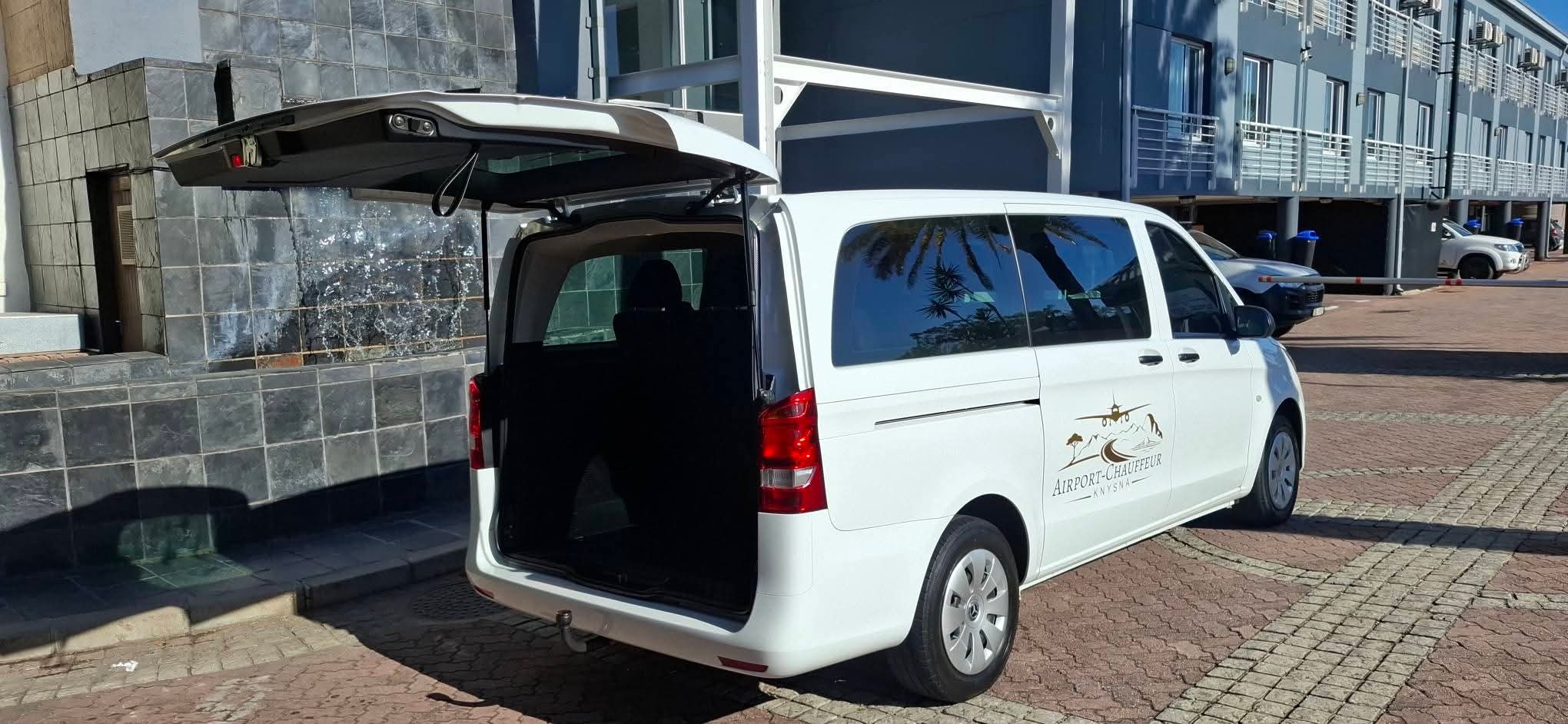 Branded white Mercedes Vito with rear tailgate open at a hotel forecourt